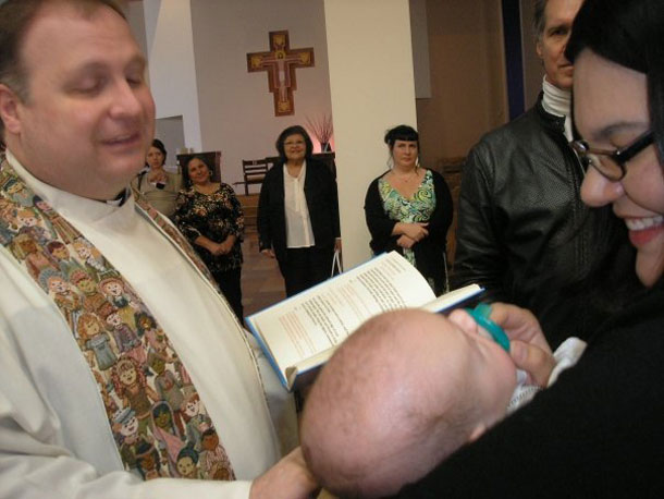 Father Dave at a baptism